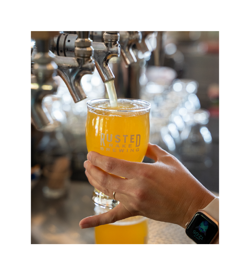 Bartender pouring beer from a rusted rake beer tap