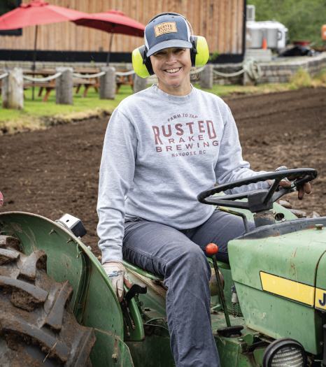 woman riding tractor 