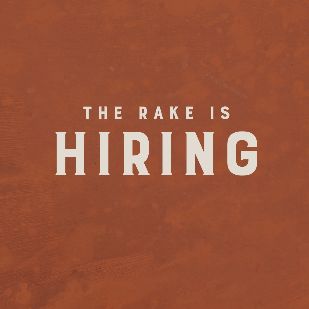 The rake is hiring graphic on a rusty background image